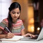 Student studying with a planner, books and laptop at a desk while following a balanced study routine