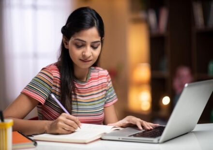 Student studying with a planner, books and laptop at a desk while following a balanced study routine